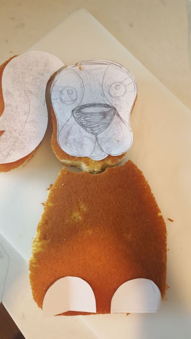 I didn t have time to scout the town for a person who could make a Cav cake, so I winged it.  I drew a dog, cut the template apart, and placed it on parts of two baked 9x13 baked cakes.  I made some home made butter cream frosting,purchased brown fondant and got to work.  I dyed a small portion of frosting black and piped it on.